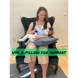 Proper ergonomics include using a pillow to support the baby while feeding
